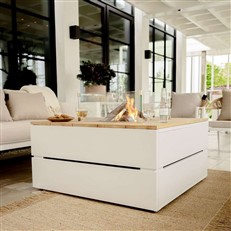 The white CosiPure 100 Fire Table in a patio setting
